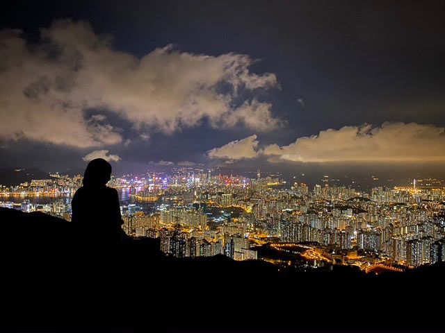 Melody overlooking the city at night